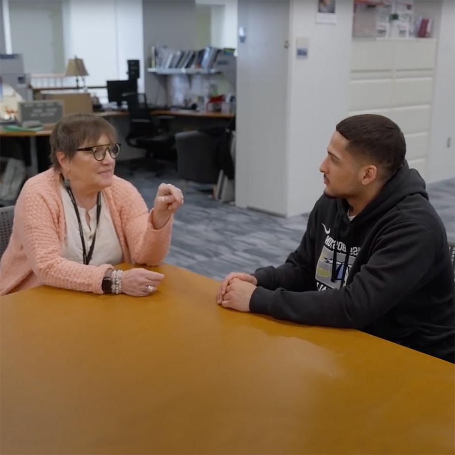 advising consultant with student at table